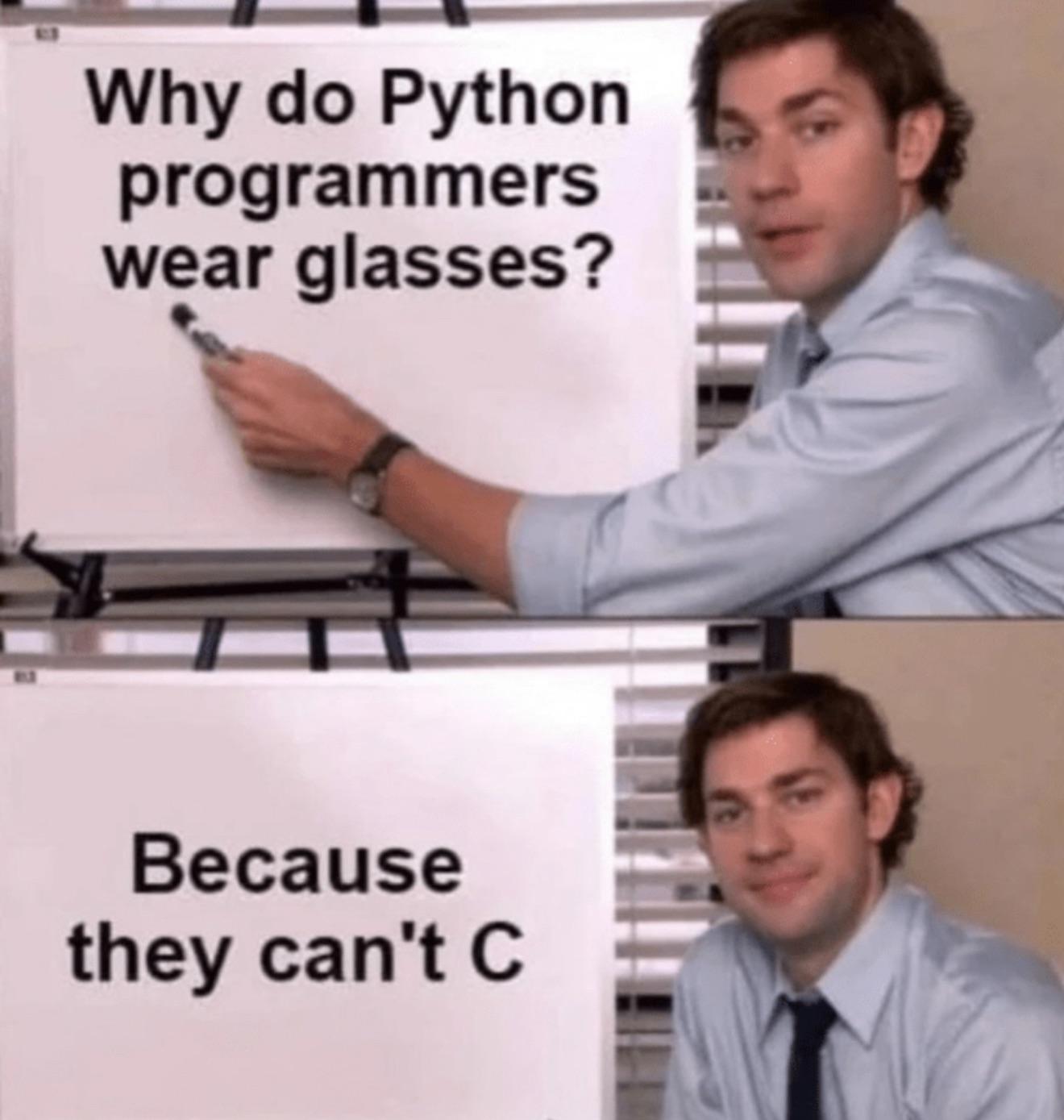 A man in an office setting points to a whiteboard that reads 'Why do Python programmers wear glasses?' and below 'Because they can't C'.